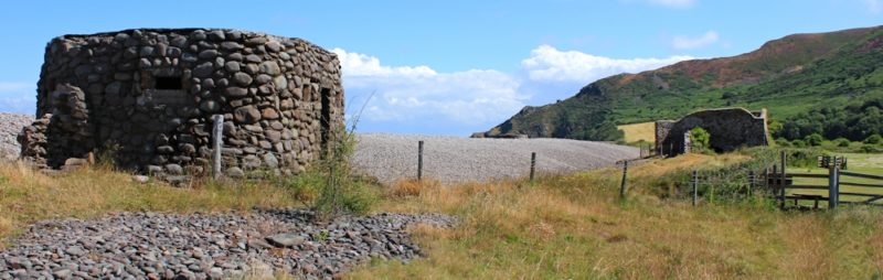 An image of Bossington beach, Exmoor. In the foreground is a WWII pillbox. In the background is a ruined 19c limekiln.