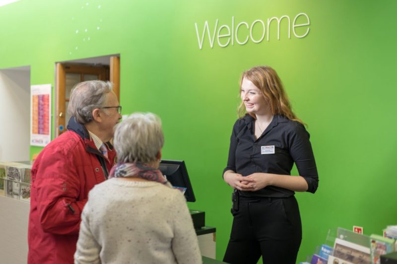 Photo of a tour guide talking to 2 people
