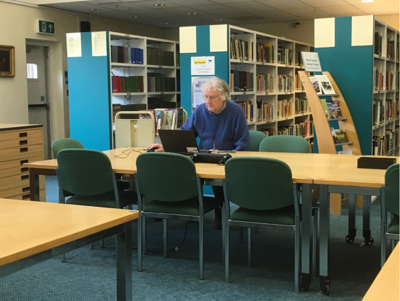 Devon Archive. person sat in search room during closed week