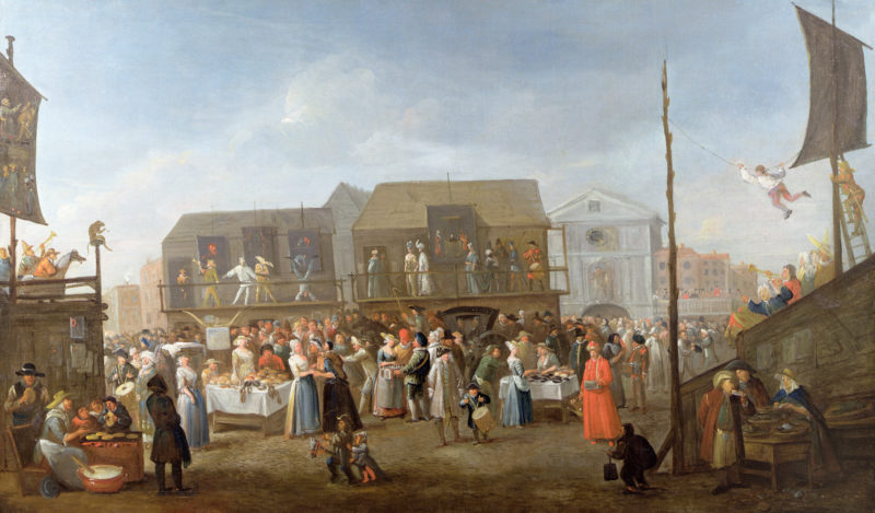 Painting showing busy fairground scene with crowds of people in foreground gathered around trade stalls. In the background are buildings and a balcony where what appears to be actors perform.