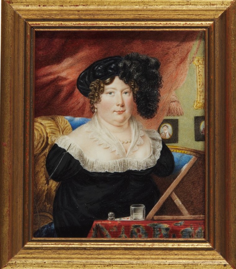 Portrait of Sarah Biffin wearing black hat and black dress. She is sat in front of a table, with a paintbrush strapped to her shoulder for painting. In the background is a red curtain and three partially-obscured portrait paintings hung on the wall.