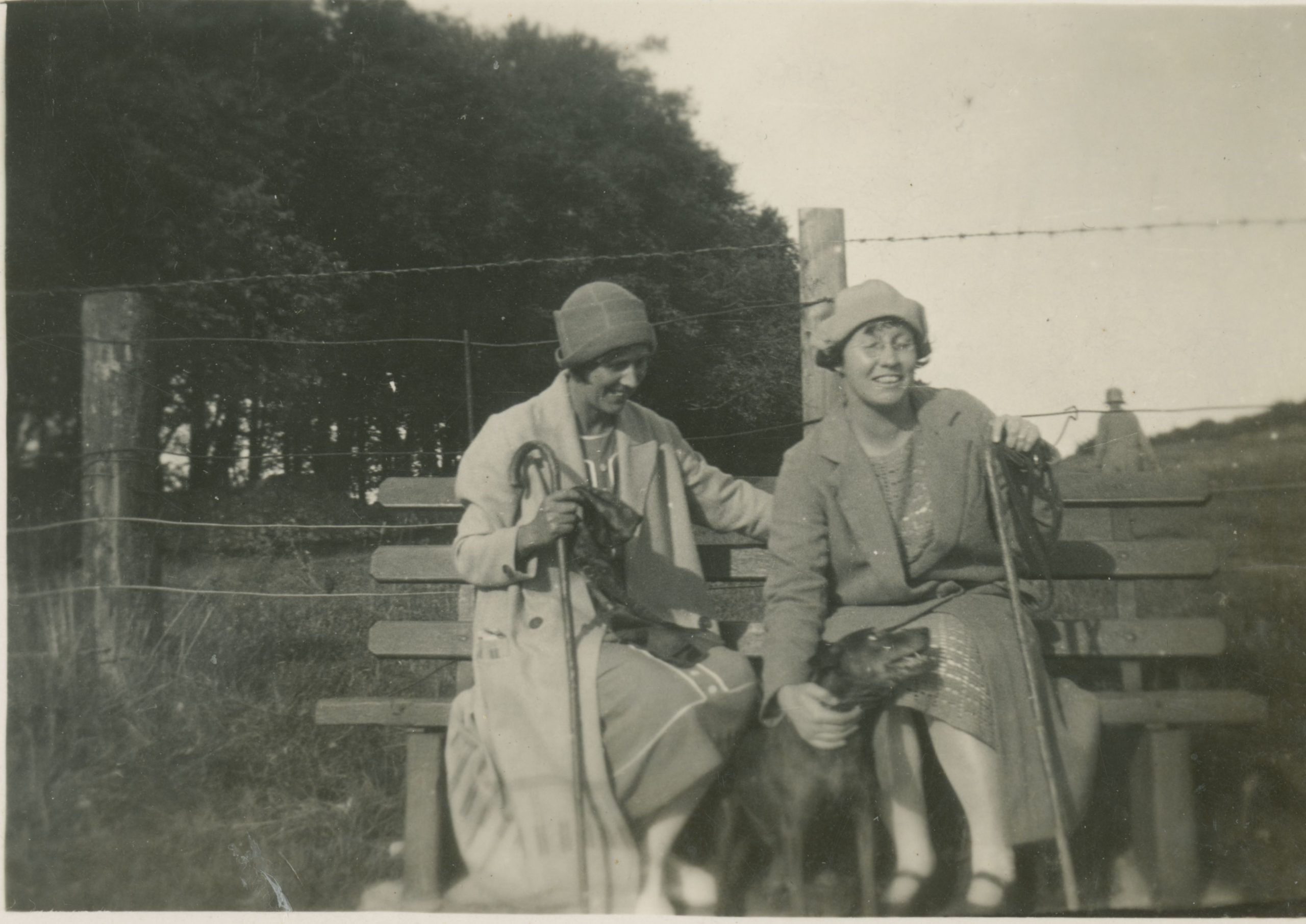 Black and white image of two women and a dog