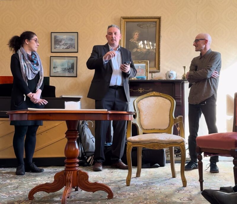 Three people stood up talking to the room.