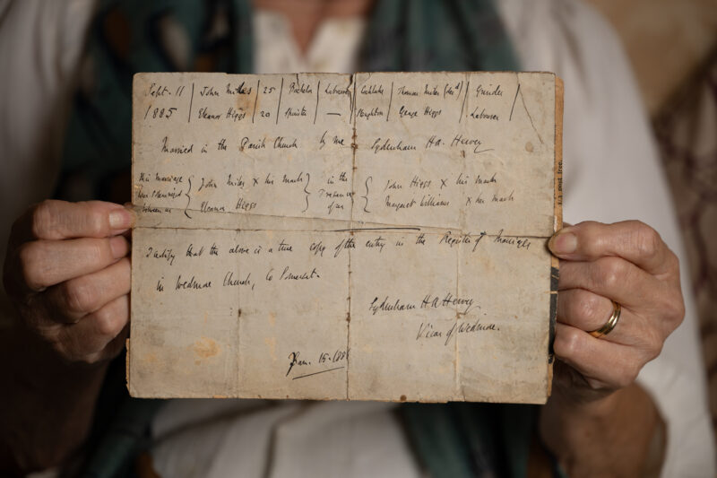 Hands holding an old letter.