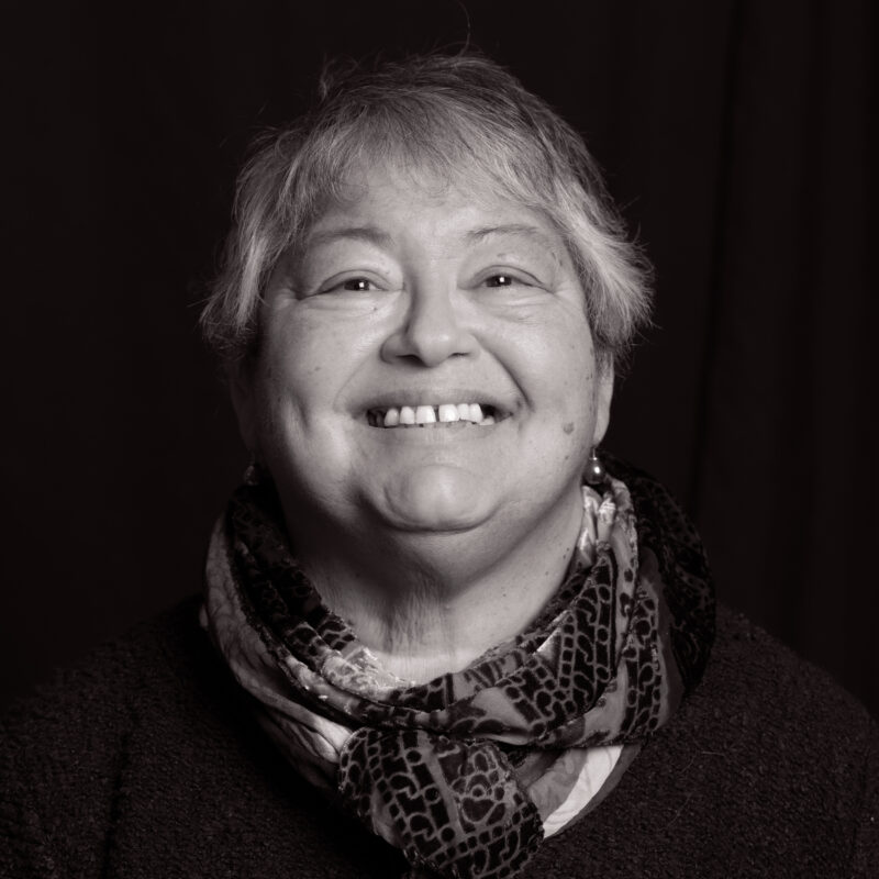 Black and white portrait of woman smiling.