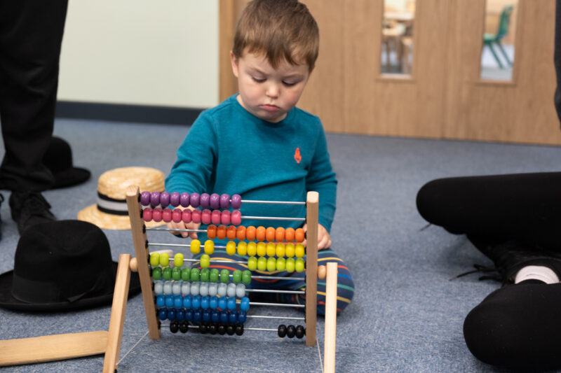 Child playing with a toy used for counting.