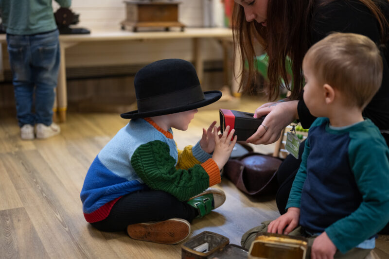 Adult showing child how to use a vintage toy.