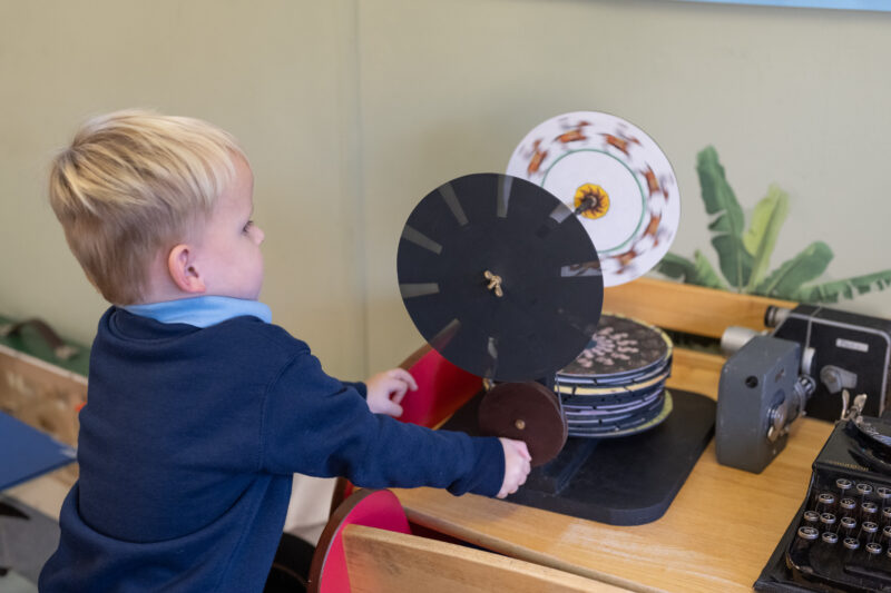 A child playing with a praxinoscope.
