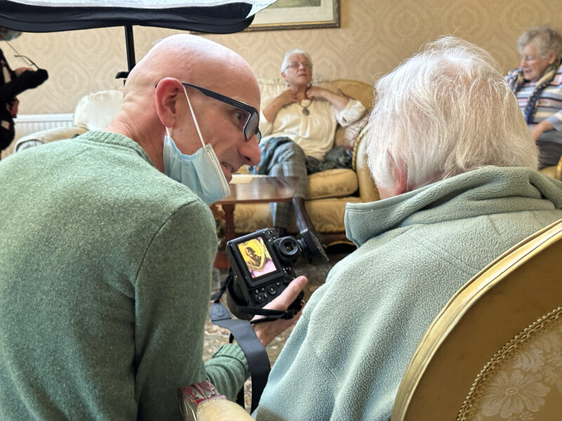 Man talking to another adult.