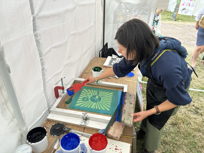 Someone making a screen print.