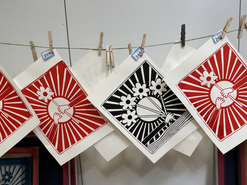 Artworks hanging to dry at event.