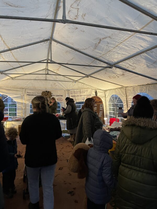 People gathered inside a marquee.