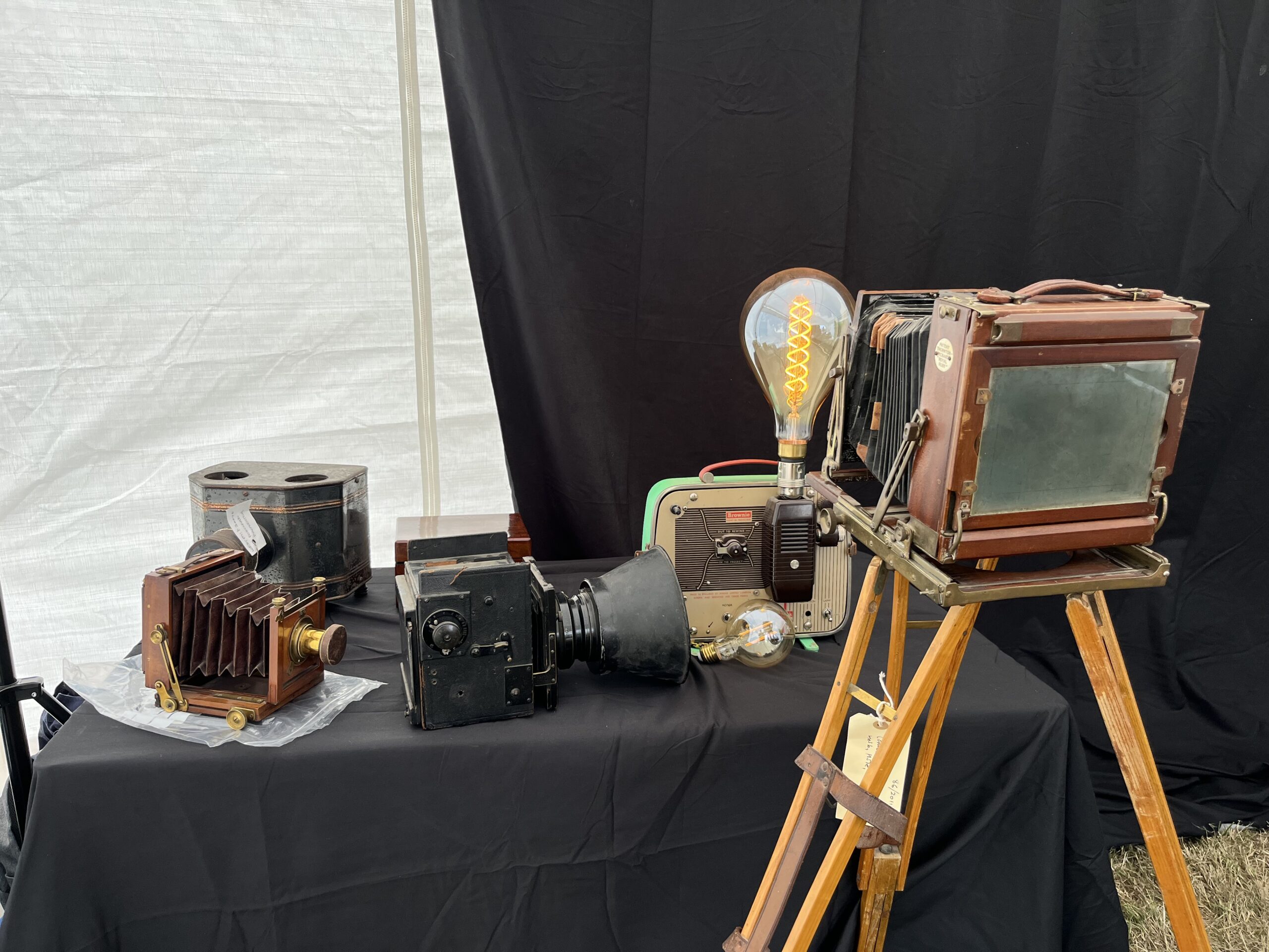 A table full of vintage camera equipment.