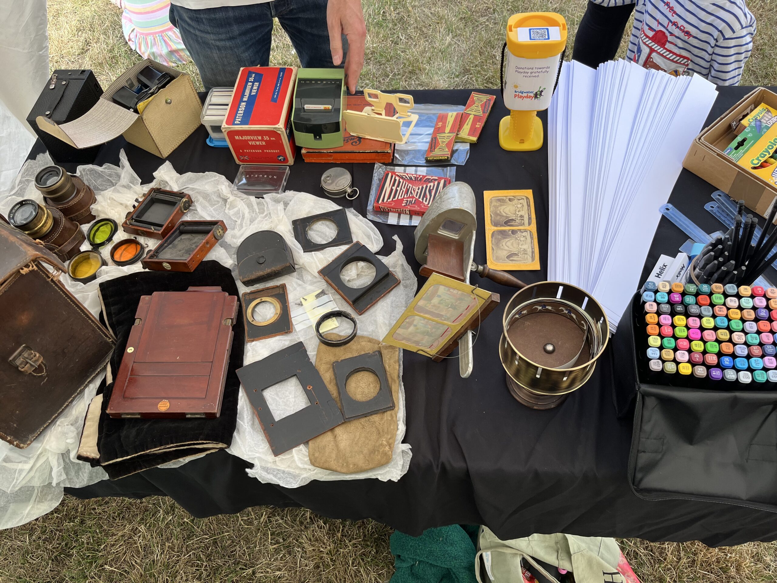 A table full of vintage camera equipment.