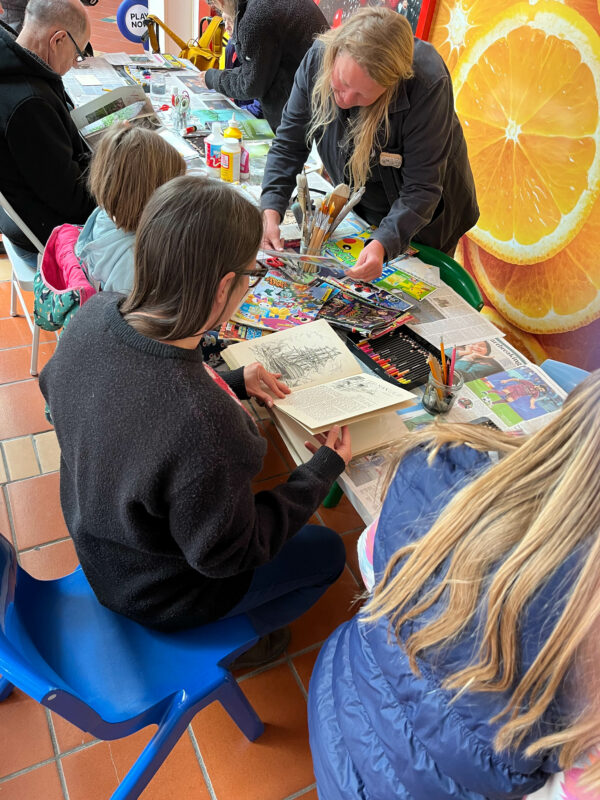 People gathered around a craft table.
