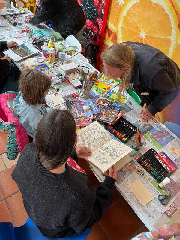 People gathered around a craft table.