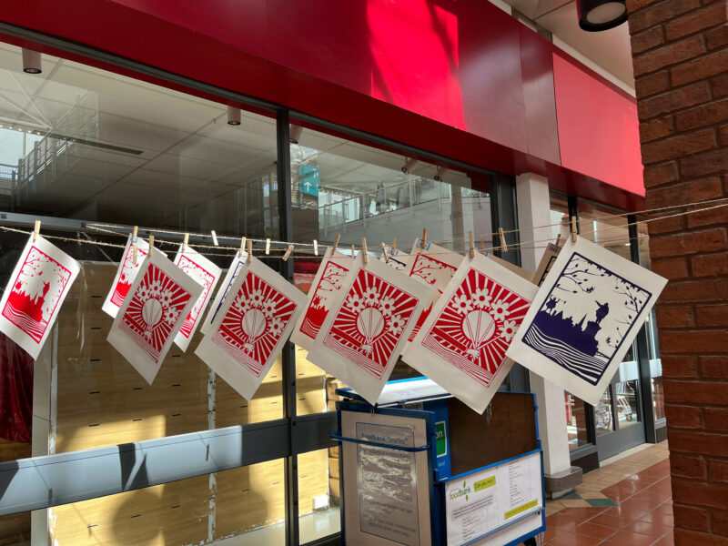 Artworks hanging from a line outside the pop-up museum.