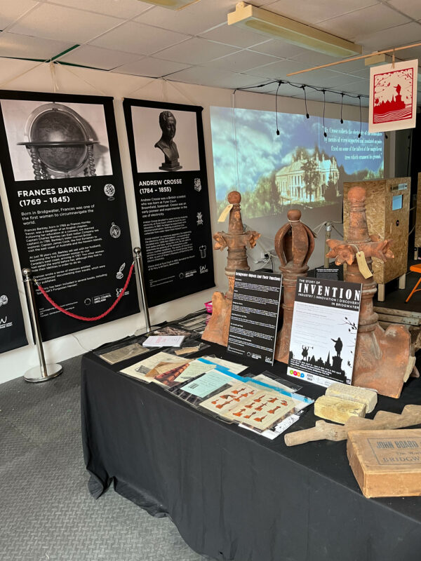 One corner of the pop-up museum, including the museum collection display, banners and an installation.