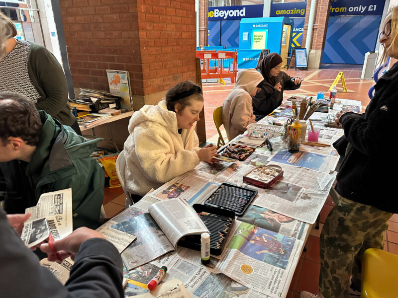 People gathered around the craft table.