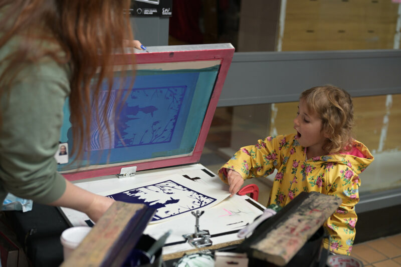 Participant engaging in the screen printing activity.