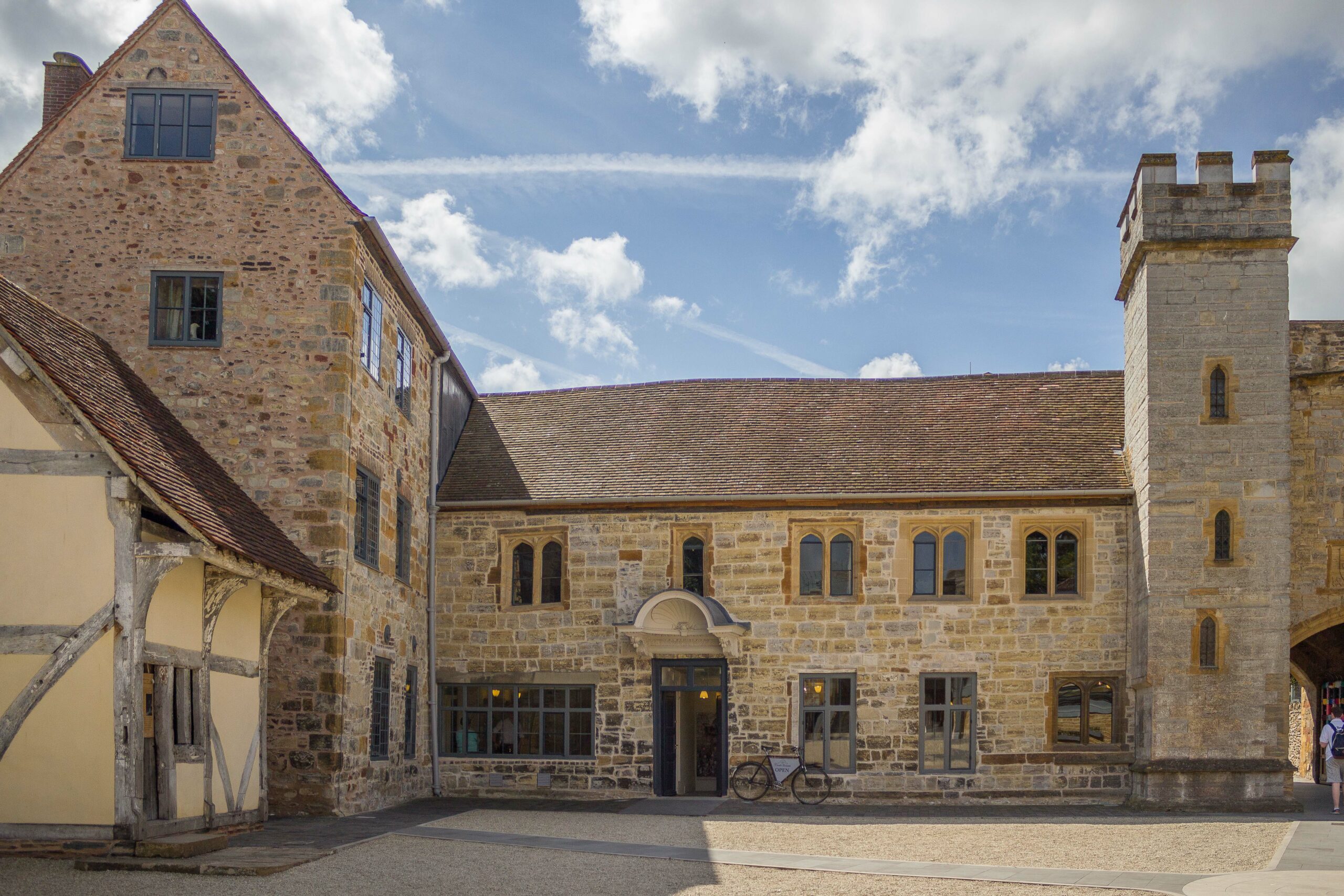 A stone-fronted building with a turret.