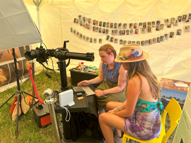 Two people sat looking at a laptop.