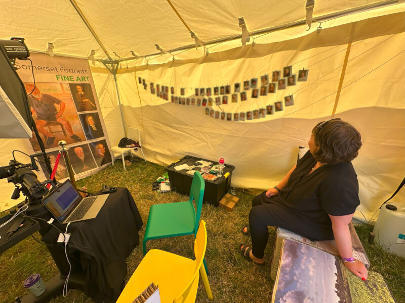 Person sat looking at portraits collected from participants.