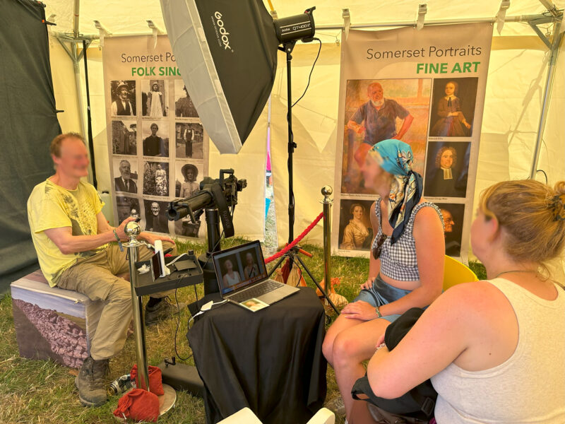 Three people inside the temporary exhibition, taking part in a photography activity.