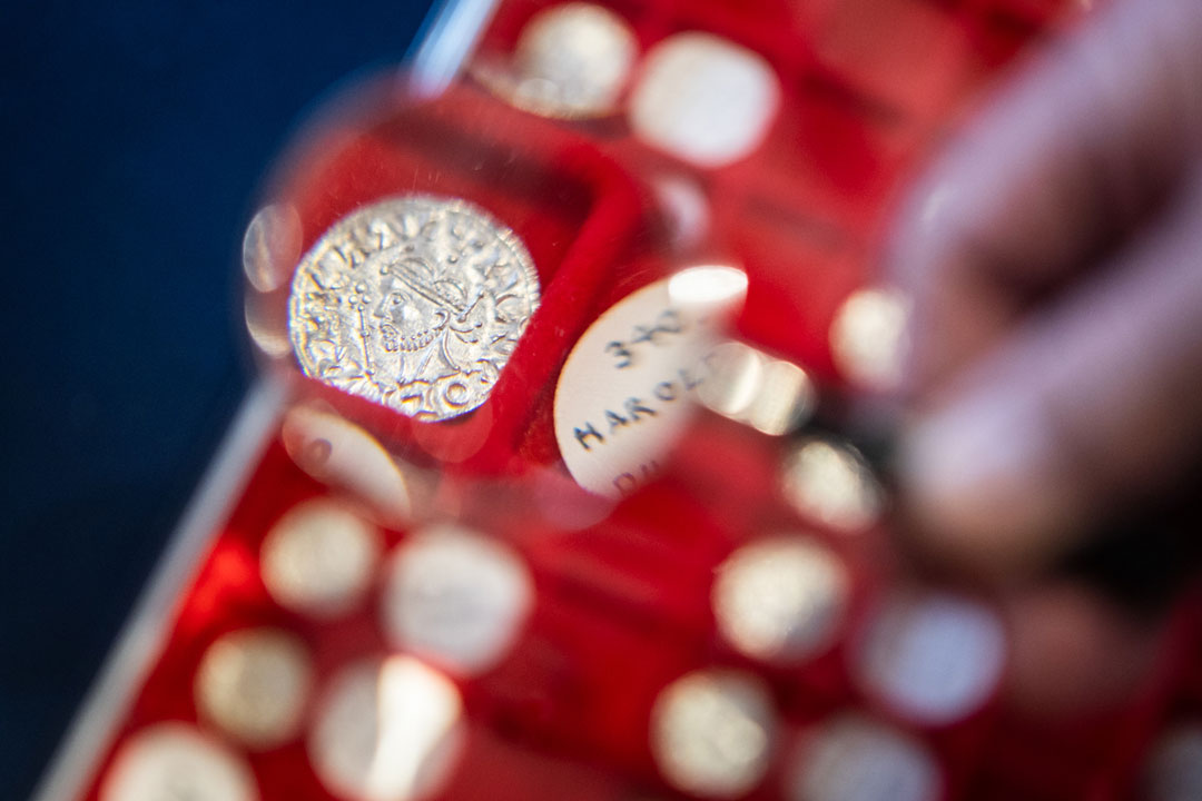 A close up photograph of a coin in a red case.