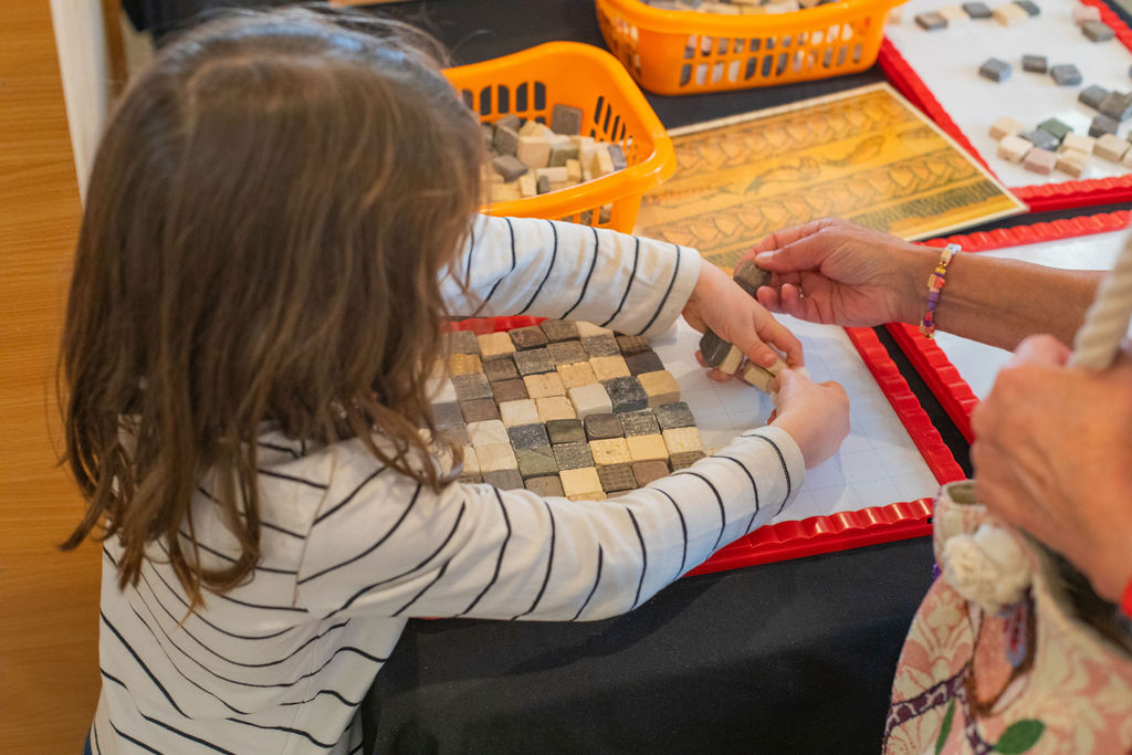 A young child playing with a mosaic activity.